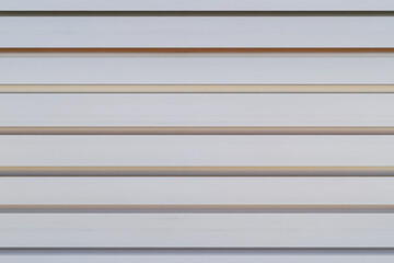 Fototapeta premium Horizontal wooden slats line the wall in a minimalist setting creating a simple yet elegant backdrop