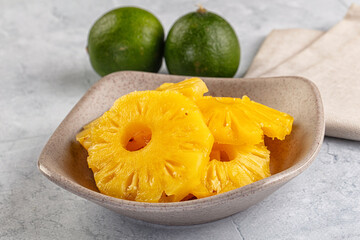 Sweet canned pineapple slices in syrope