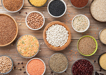 Bulgur,beans,quinoa,pea,couscous and hemp with chickpea and buckwheat seeds in various bowl plates...