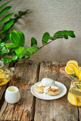 Breakfast. Syrniki with cream sauce. Lemon, rosemary and quince tea