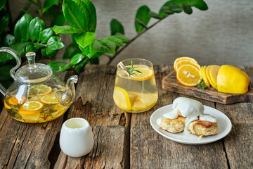 Breakfast. Syrniki with cream sauce. Lemon, rosemary and quince tea