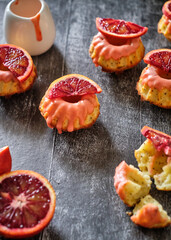 Poppy seed cupcakes with red oranges. Decorated with pink icing and blood oranges in syrup.
