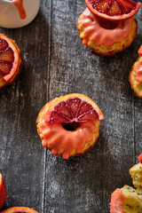 Poppy seed cupcakes with red oranges. Decorated with pink icing and blood oranges in syrup.