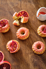 Poppy seed cupcakes with red oranges. Decorated with pink icing and blood oranges in syrup.