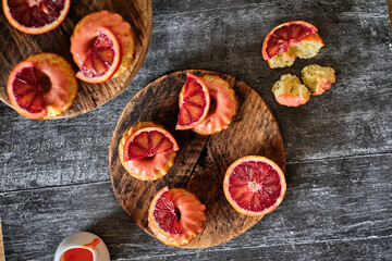 Poppy seed cupcakes with red oranges. Decorated with pink icing and blood oranges in syrup.