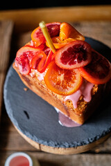 Poppy seed cake with blood oranges. Decorated with pink icing and blood oranges in syrup.