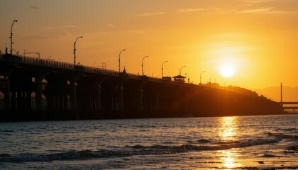Obraz premium Sunset Over Pier with Silhouetted Structure and Calm Waters