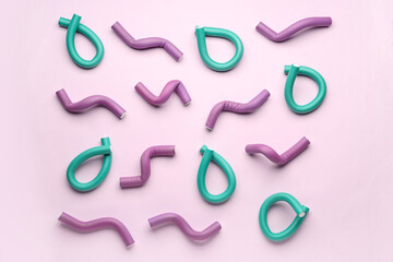 Hair curlers on pink background