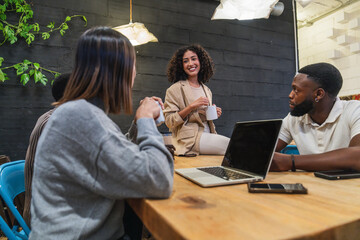 Young professionals collaborating on project in modern coworking space