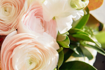 Fototapeta premium Beautiful holiday card. Mother Day greeting card. Delicate bouquet of white ranunculus and pastel tulips with soft green leaves, creating a romantic and elegant floral scene