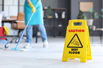 Caution sign on floor in office, closeup