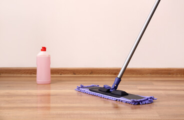 Cleaning of wooden laminate floor with mop and detergent, closeup