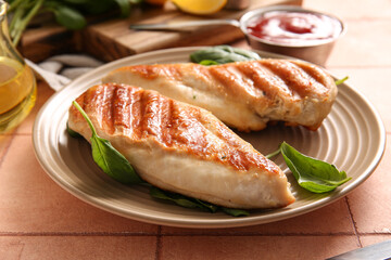 Plate with tasty grilled chicken breast and basil on pink tile background