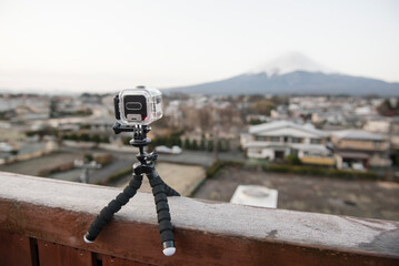 Action camera set up on a tripod, capturing the view of Mount Fuji