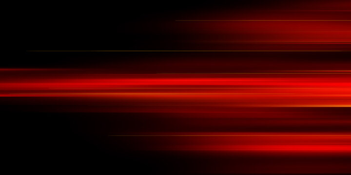 The effect of red light in fast motion on a black background. blurred abstract background with long exposure. neon light