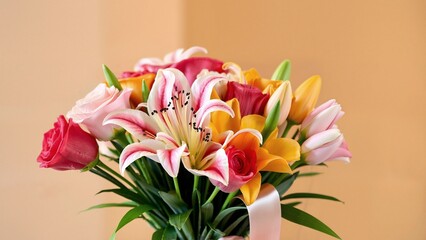 A stunning bouquet of colorful roses, lilies, and tulips tied with a silk ribbon. Vibrant, fresh, and elegant floral arrangement on a softly blurred background, celebrating beauty and joy