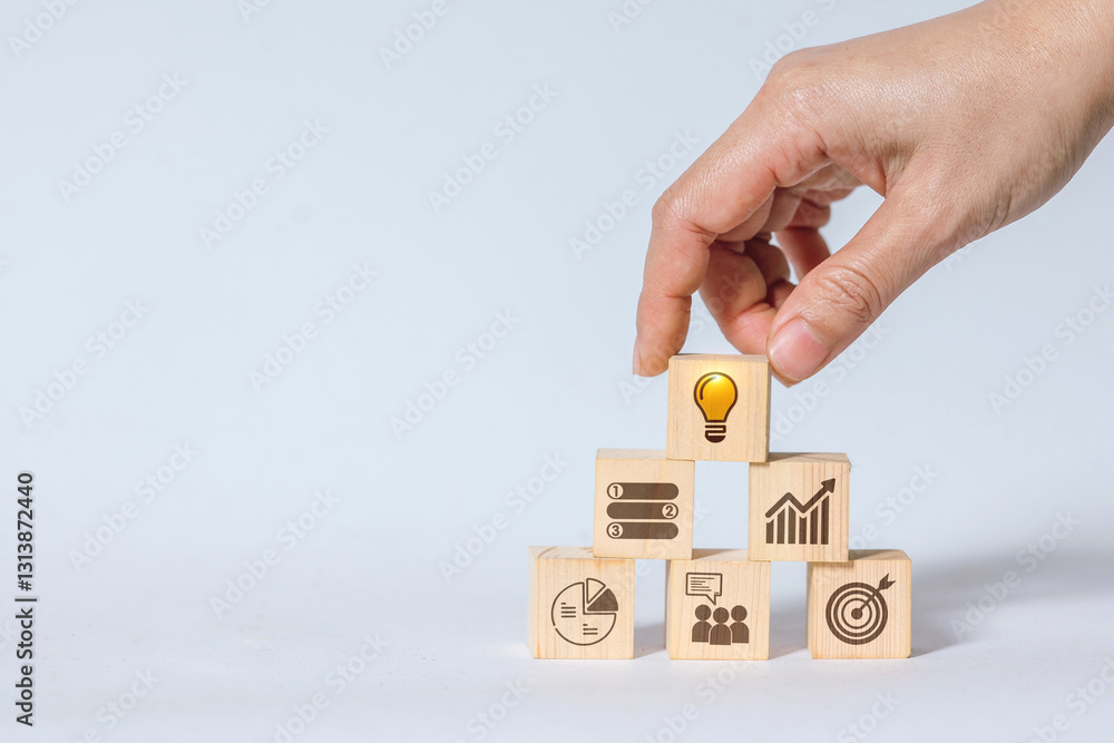Poster hands placing wooden blocks with light bulb icons on a block pyramid with business and strategy symb