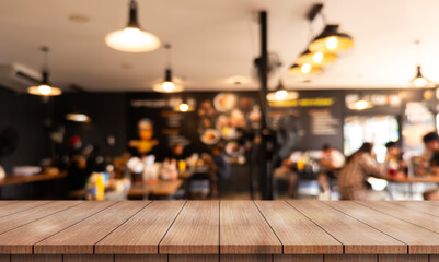 Empty wooden table top with lights bokeh on blur restaurant background.