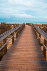 Fototapeta premium Ocean Beach in Portugal with Wooden Boardwalks. Scenic wooden pathways stretch along the coastline, inviting peaceful walks and endless exploration