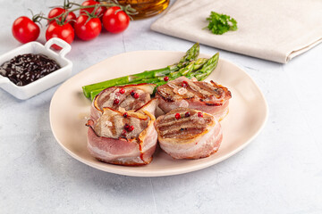 Tasty grilled pork medallion with bacon