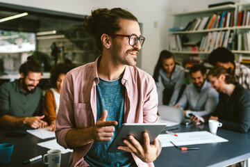 Portrait of happy success man working in a busy modern workplace, Startup coworker concept