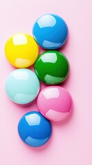 Colorful Round Candy Pieces Grouped on Pink Background Sweet Treats Arrangement Still Life