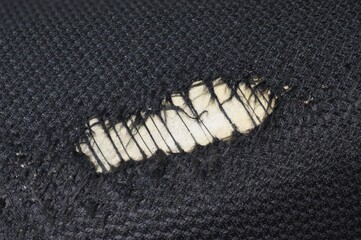 Worn spot in fabric of a foam seat cushion