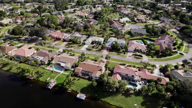 Aerial: West Palm Beach residential zone during the day, push in tilt down drone shot, USA
