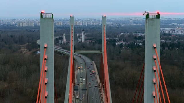 Aerial drone view of Siekierkowski Bridge in Warsaw at sunset with city in distance