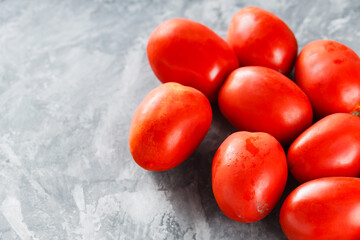 Freshly Harvested Plum Tomatoes on Grey Background for Healthy Seasonal Nutrition, Copy Space