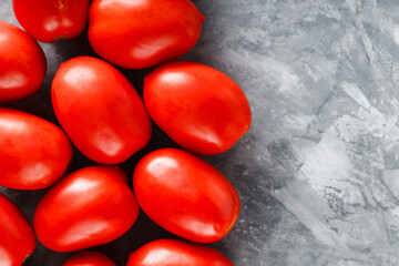 Freshly Harvested Plum Tomatoes on Grey Background for Healthy Seasonal Nutrition, Copy Space