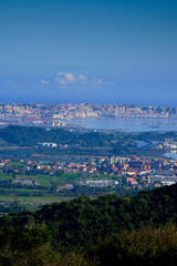 Santander and Astillero cities with industrial port and cityscape.