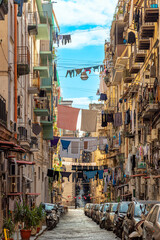 Clotheslines and clothes to dry between the houses and above the street of the Centro Storico, the lively old town of Naples. 