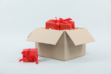 Parcel with gift boxes on light background