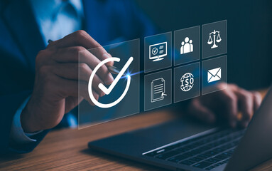 Compliance in business to laws and regulations, ethical operations. businessman hand holding compliance icons on a virtual screen symbolizes the commitment to enforce standards and internal policies.