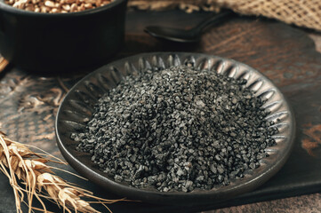 Black salt close-up. Himalayan black salt crystals. Black Russian rye Thursday salt