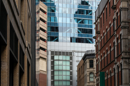 Historic and modern buildings in downtown Boston featuring intricate facades, brickwork, and Art Deco details. The urban architecture highlights the city's rich architectural heritage and design style