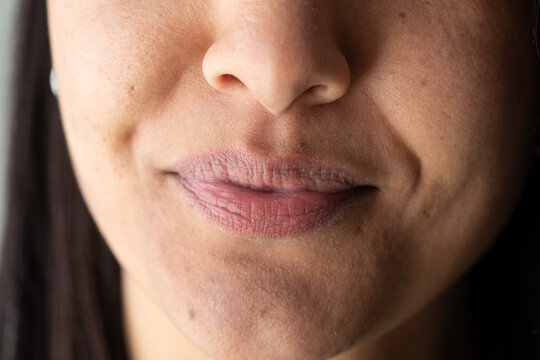 Woman showing slight smile and dimples on face