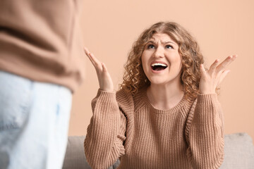 Unhappy couple quarreling in living room