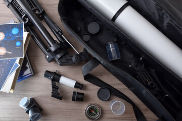 Telescope and parts with books as an astronomy hobby © Davizro Photography