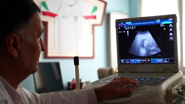 Gynecologist checking baby sonogram scanner. Rack focus