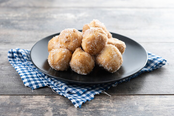 Traditional Carnival fritters or buñuelos de viento on wooden table