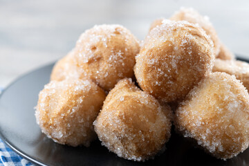 Traditional Carnival fritters or buñuelos de viento on wooden table. Close up