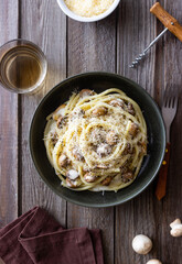Bucatini pasta in creamy sauce with mushrooms and cheese. Vegetarian food. Italian cuisine.