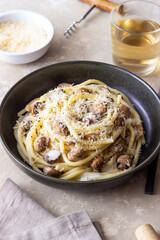 Bucatini pasta in creamy sauce with mushrooms and cheese. Vegetarian food. Italian cuisine.