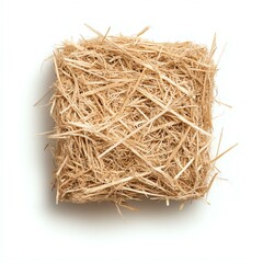 Square bale of straw on a white surface.