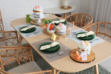 Festive table setting with Easter cakes and decor in dining room. Closeup