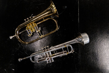 musical instruments, trumpets placed on a black table