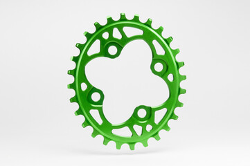 Green oval bicycle chainring against white isolated background, hanged in the air, floating above...