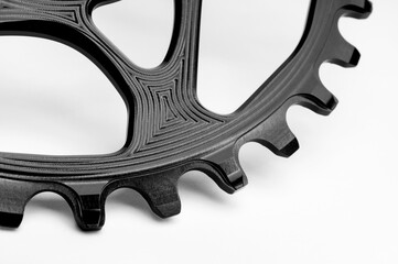 Close up of a black oval bicycle chainring against white isolated background. Professional bicycle...